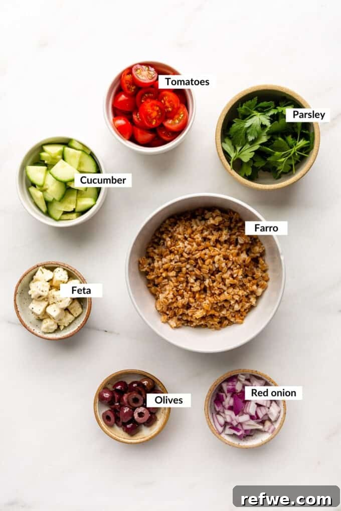 Mediterranean Farro and Feta Salad 3 A vibrant selection of fresh ingredients laid out, ready for preparing the Greek Farro Salad.