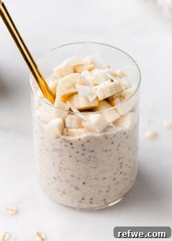 A delicious cup of banana overnight oats, perfectly prepared and ready to be enjoyed, with a spoon artistically placed for illustrative purposes.