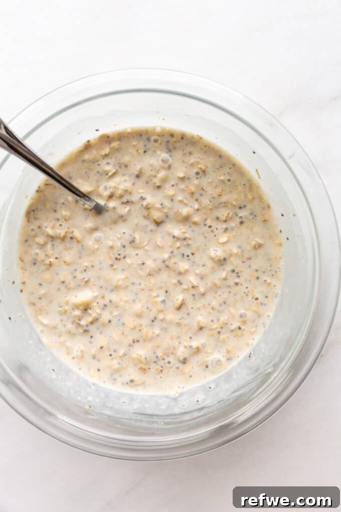Creamy Banana Overnight Oats 7 The banana overnight oats mixture, fully combined in a mixing bowl, showing a smooth and even consistency before refrigeration, with all ingredients perfectly integrated.