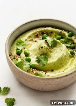 Green pea hummus in a ceramic bowl