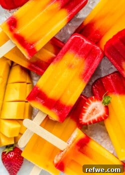 strawberry mango popsicles stacked on ice