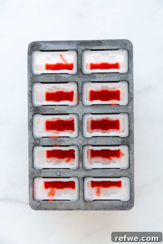 strawberry puree in a popsicle mold