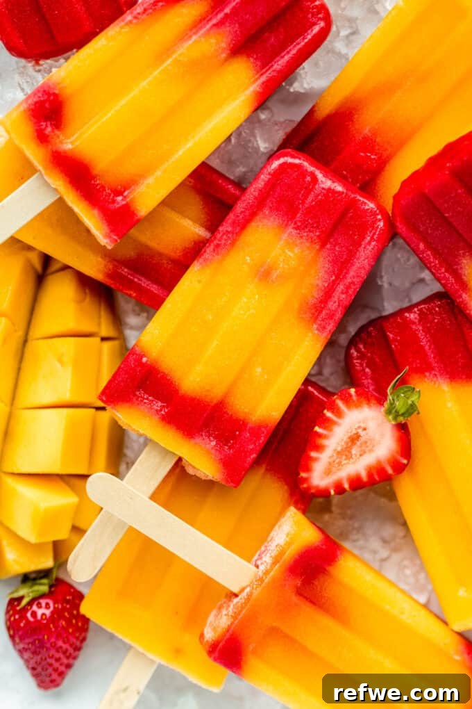strawberry mango popsicles stacked on ice
