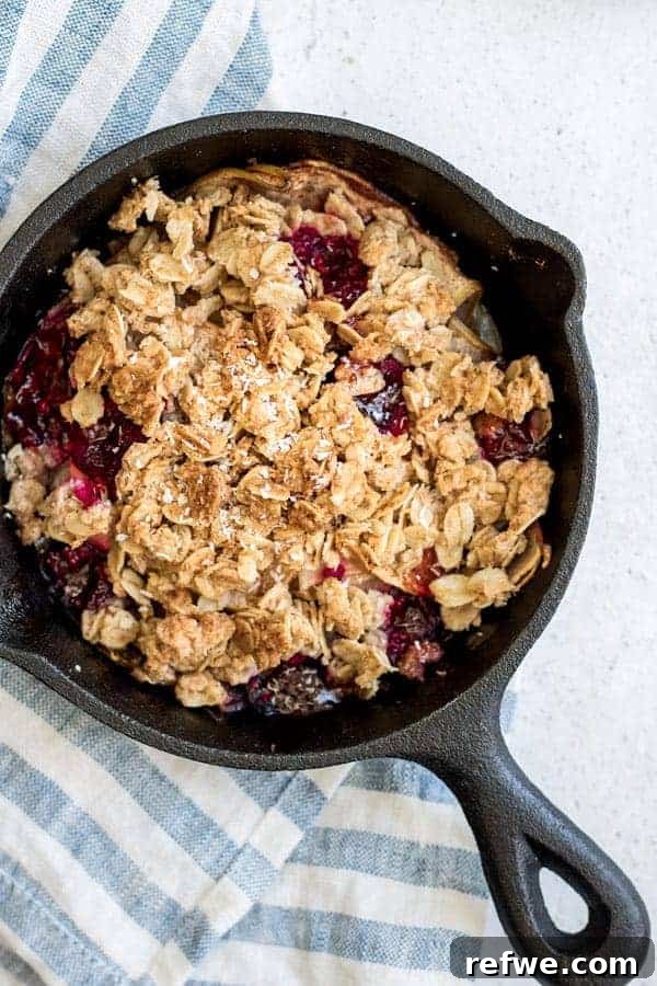 Savor the Season: 14 Fall Apple Recipes 12 Warm Apple Raspberry and Coconut Crisp bubbling with fruit and a golden topping in a white baking dish.