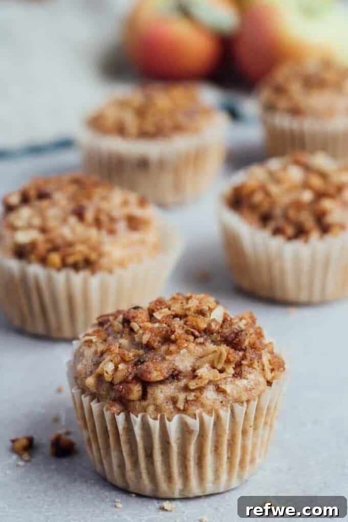 Savor the Season: 14 Fall Apple Recipes 6 A batch of perfectly baked Vegan Apple Crumb Muffins with golden, streusel topping, cooling on a wire rack.