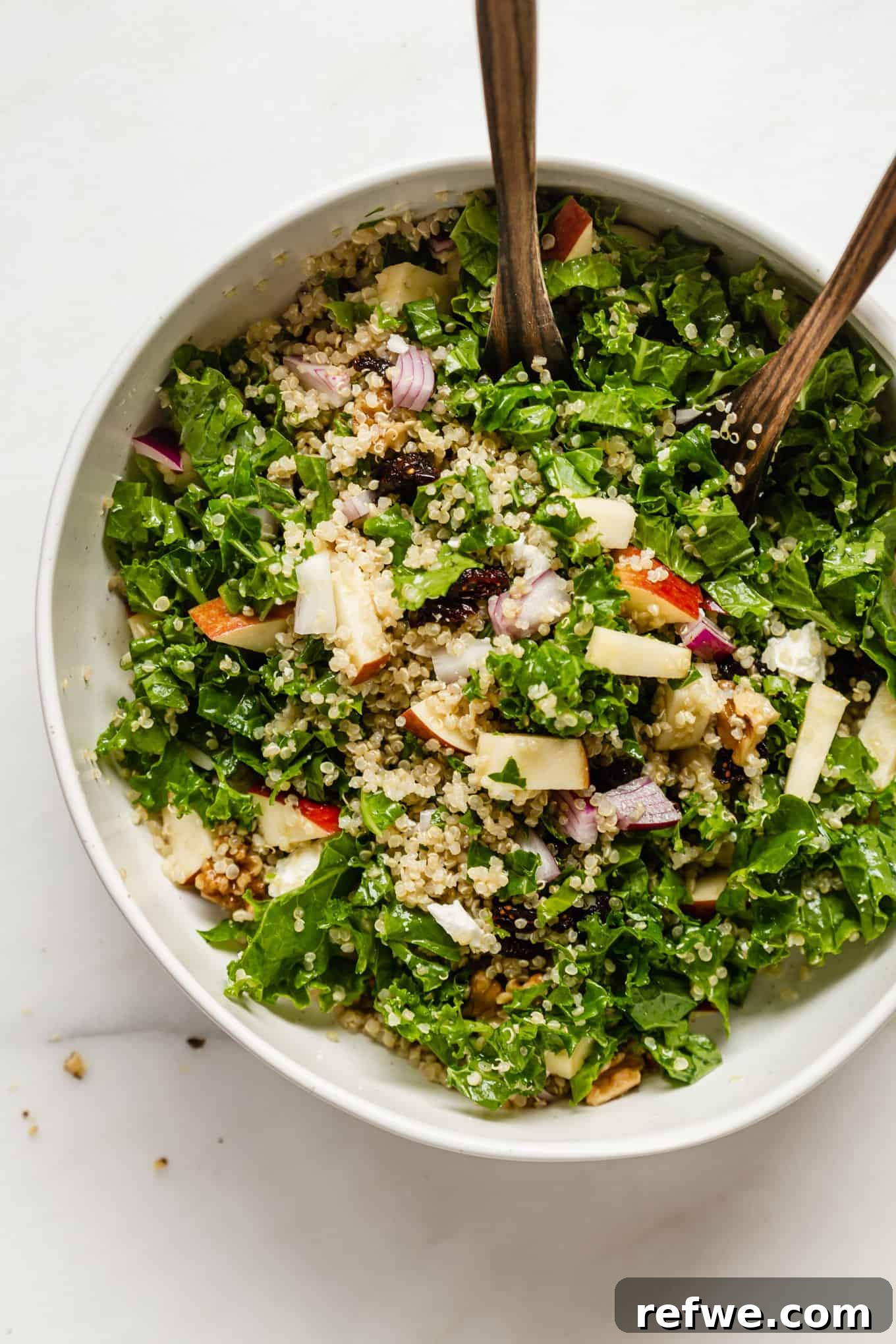Vibrant Apple Cranberry Quinoa Salad 2 A vibrant Apple Cranberry Quinoa Salad served in a pristine white bowl, showcasing fresh ingredients.