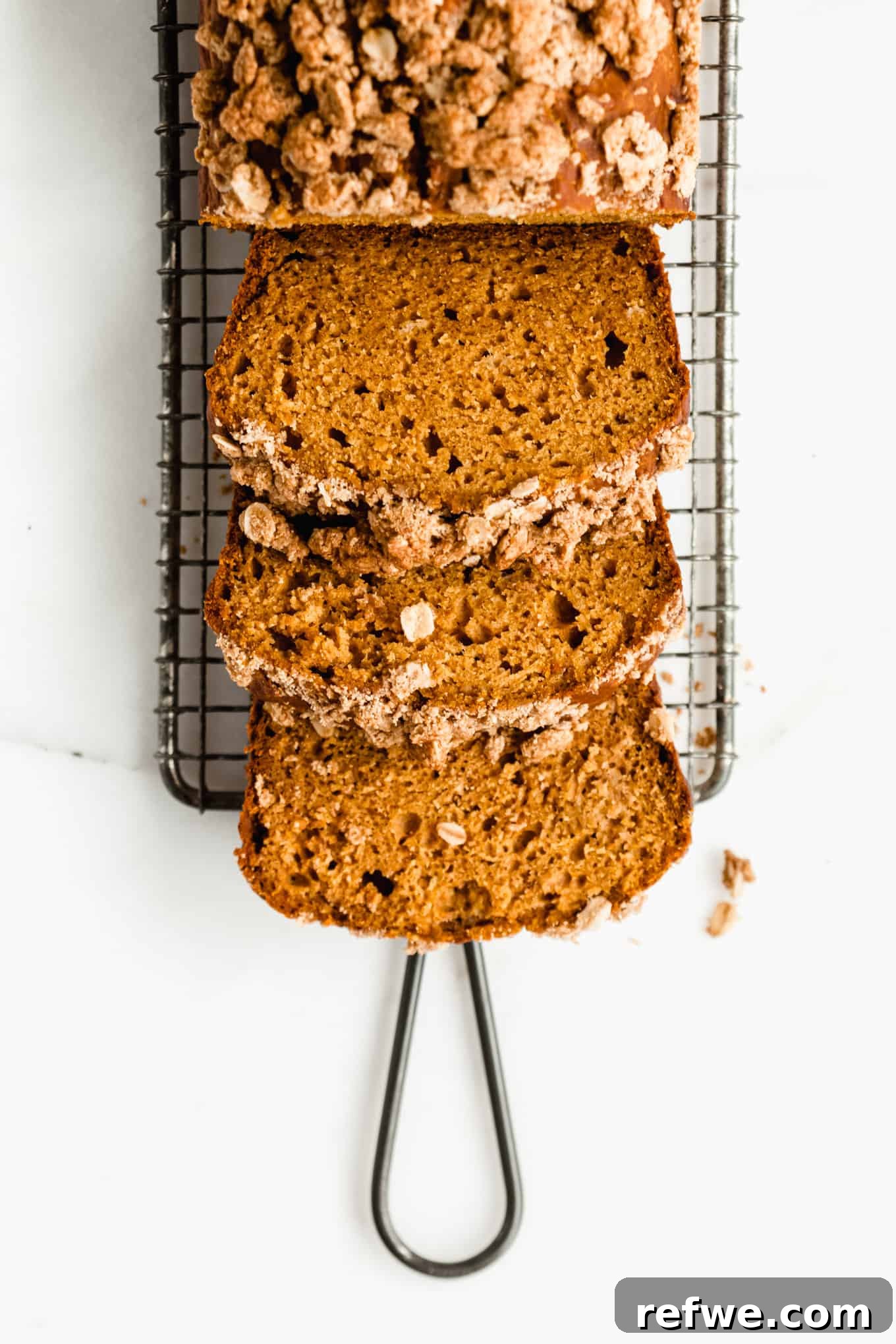 Wholesome Pumpkin Banana Loaf 2 Pumpkin banana bread sliced on a cooling rack
