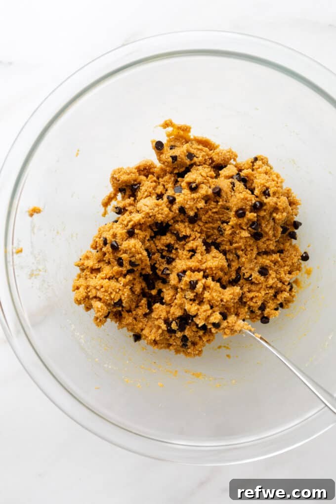 The pumpkin protein ball dough in a mixing bowl after all ingredients have been thoroughly combined.