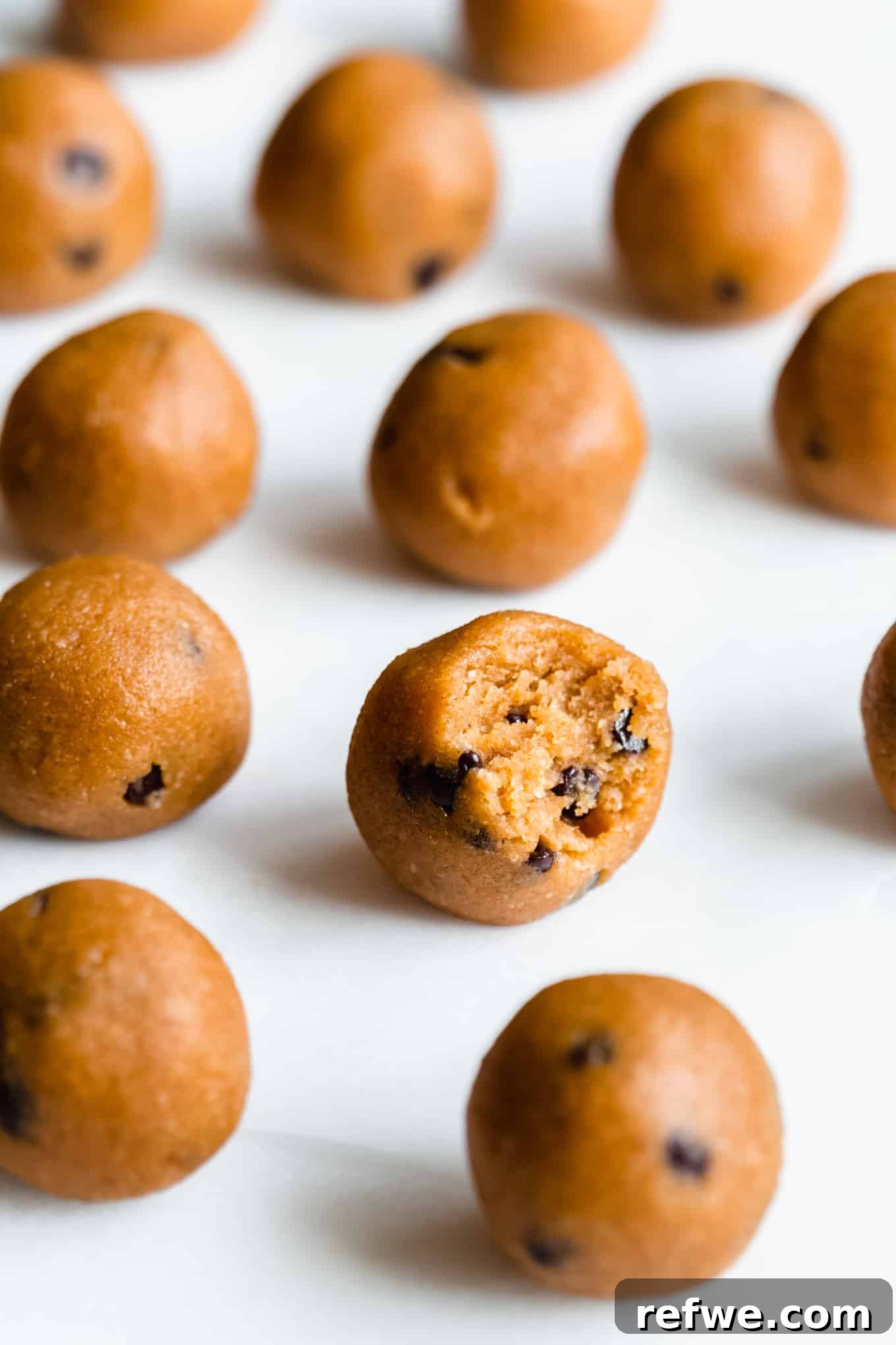 A cluster of pumpkin protein balls arranged artfully on a marble board, ready to be served.