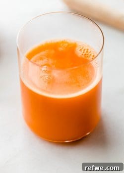 Zingy Ginger Carrot Orange Immunity Nectar 10 A glass of vibrant orange, carrot, and ginger juice, ready to be enjoyed as a healthy immune booster.