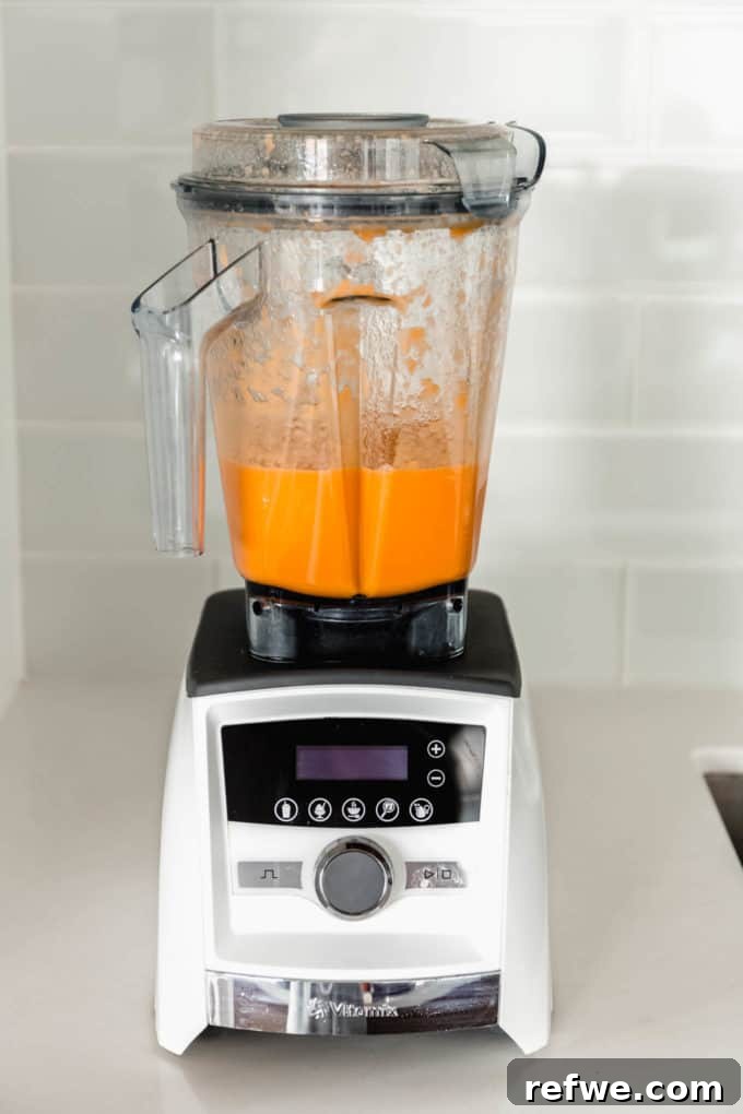 Zingy Ginger Carrot Orange Immunity Nectar 5 A blender containing the smoothly blended mixture of orange, carrot, and ginger, illustrating the liquid consistency after processing.