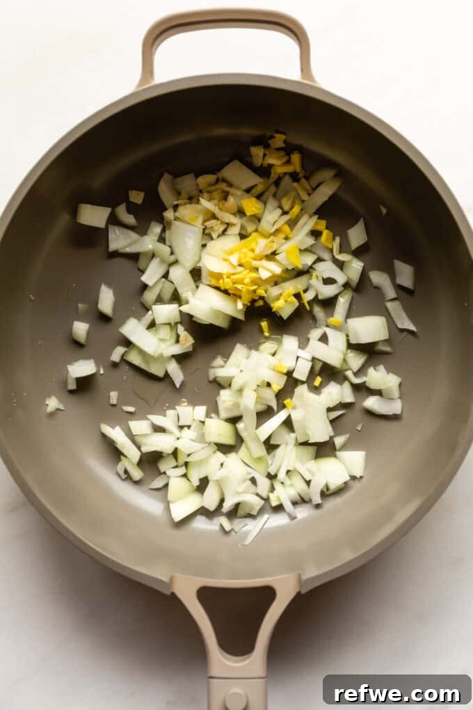 Golden Cauliflower Chickpea Curry 4 onions, garlic and ginger in a pan