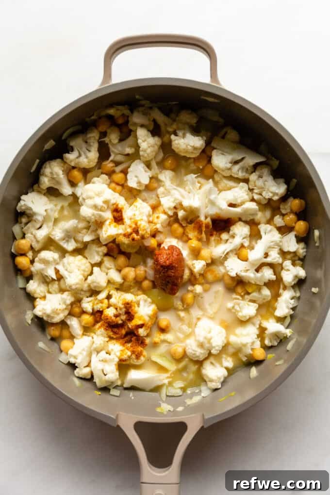 Golden Cauliflower Chickpea Curry 5 cauliflower, chickpeas, curry paste and coconut milk in a pan