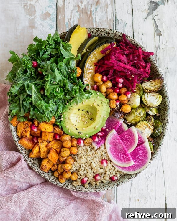 Close-up of a healthy vegan fall harvest buddha bowl with roasted sweet potato, brussels sprouts, and chickpeas, highlighting the nourishing ingredients.