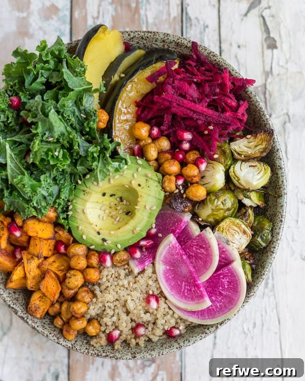Overhead view of a Fall Harvest Buddha Bowl ingredients being prepared, showing fresh sweet potatoes, brussels sprouts, squash, and chickpeas.