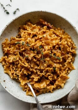 One-Pot French Onion Pasta ready to serve in a dish.