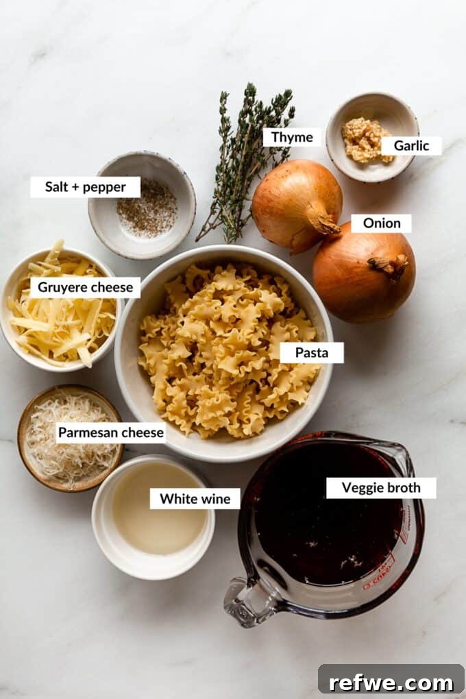 Creamy French Onion Pasta Skillet 3 Collection of fresh ingredients for French Onion Pasta including onions, cheese, pasta, wine, and herbs.