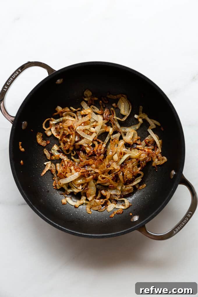 Creamy French Onion Pasta Skillet 5 Close-up of deeply caramelized onions in a pot, rich golden brown and tender.