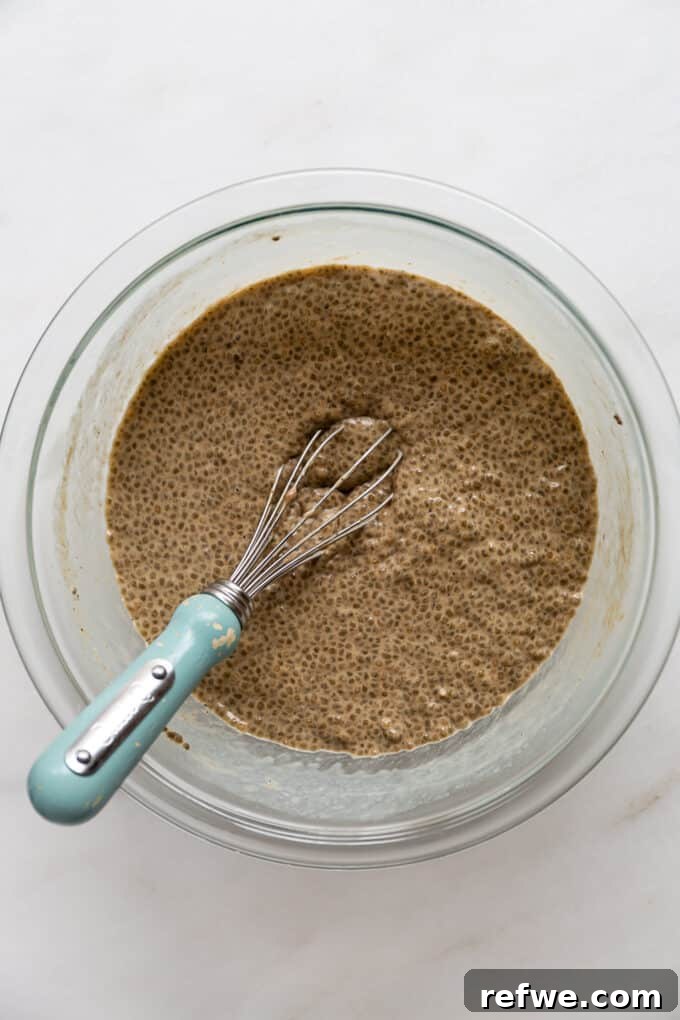 Gingerbread Spice Chia Delight 5 A bowl of gingerbread chia pudding is shown with a whisk inside, indicating it's freshly made and ready for chilling.