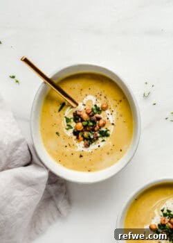 A bowl of curried cauliflower soup topped with crispy chickpeas and cilantro