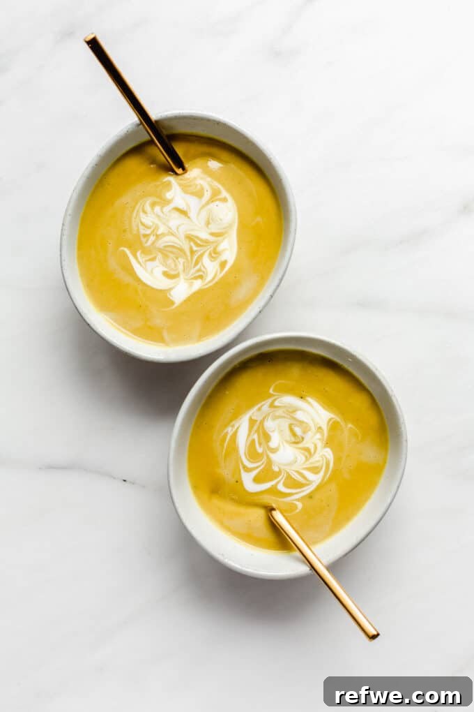 Velvety Curried Cauliflower Bliss 9 Two bowls of finished curried cauliflower soup, each garnished with a swirl of coconut milk and fresh cilantro.