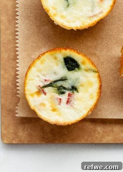 A perfectly cooked egg white bite on a wood cutting board, ready to be enjoyed as a healthy breakfast.