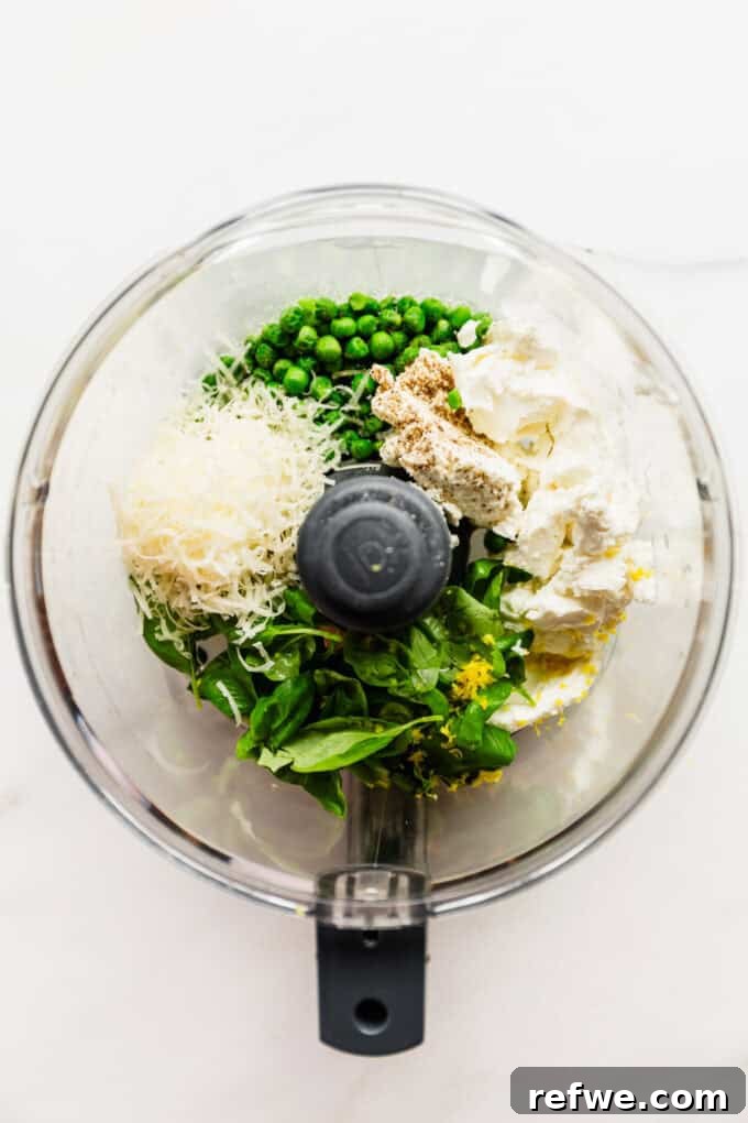 Spring Pea Ricotta Pasta 3 Ricotta cheese, cooked peas, parmesan, fresh basil, and lemon zest being added to a food processor.