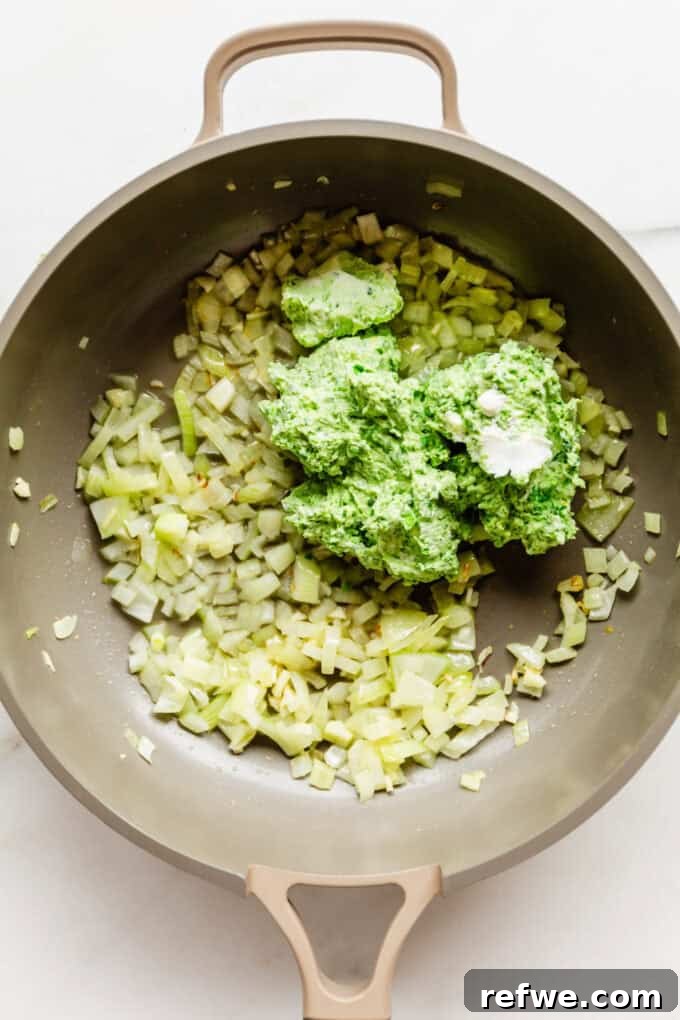 Spring Pea Ricotta Pasta 6 The onion, garlic, and ricotta pea mixture simmering gently in a pan, ready to be stirred into a sauce.