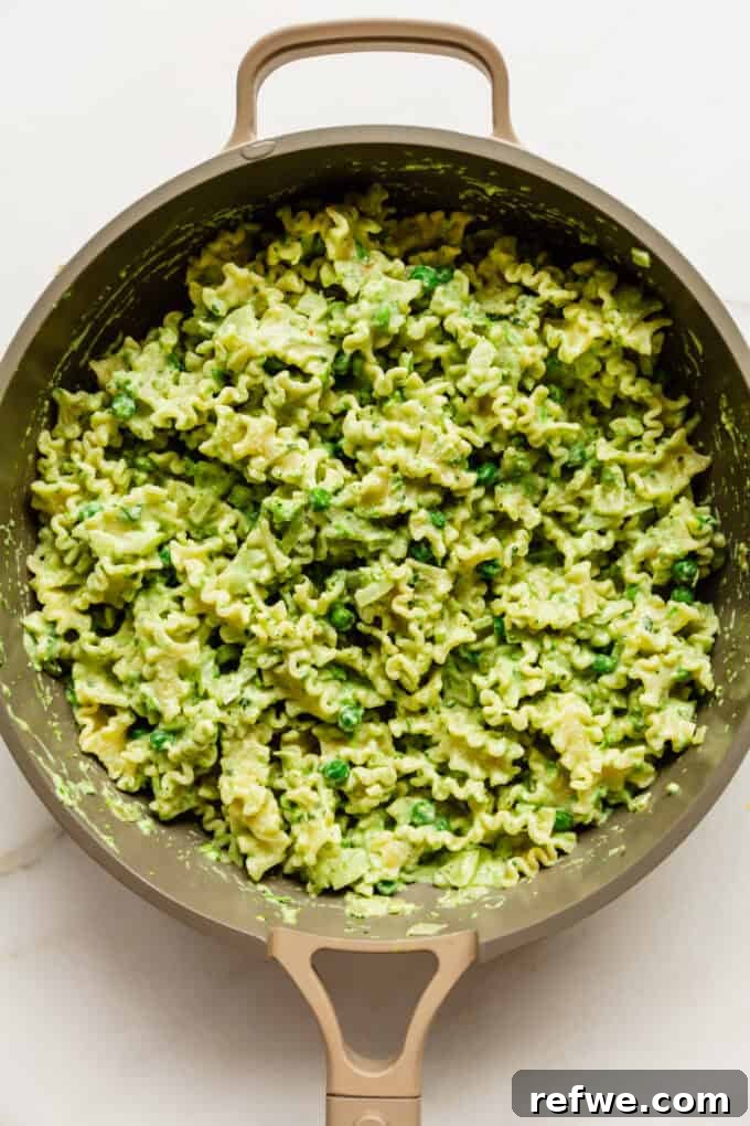 Spring Pea Ricotta Pasta 9 Creamy ricotta and pea pasta, perfectly mixed and ready to serve, in a pan.