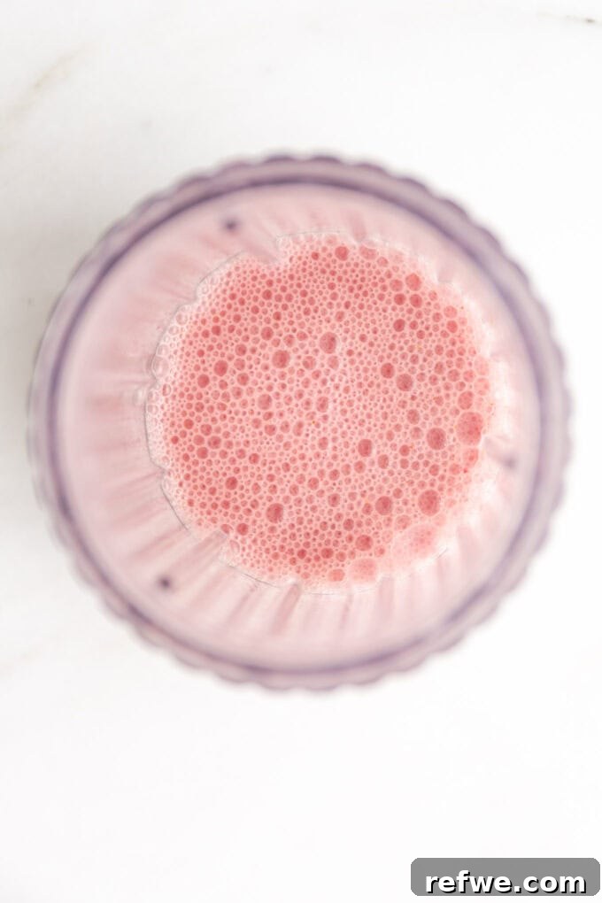 Dreamy Strawberry Overnight Oats 5 Blended smooth strawberry milk in a blender jug, ready to be combined with the dry ingredients.