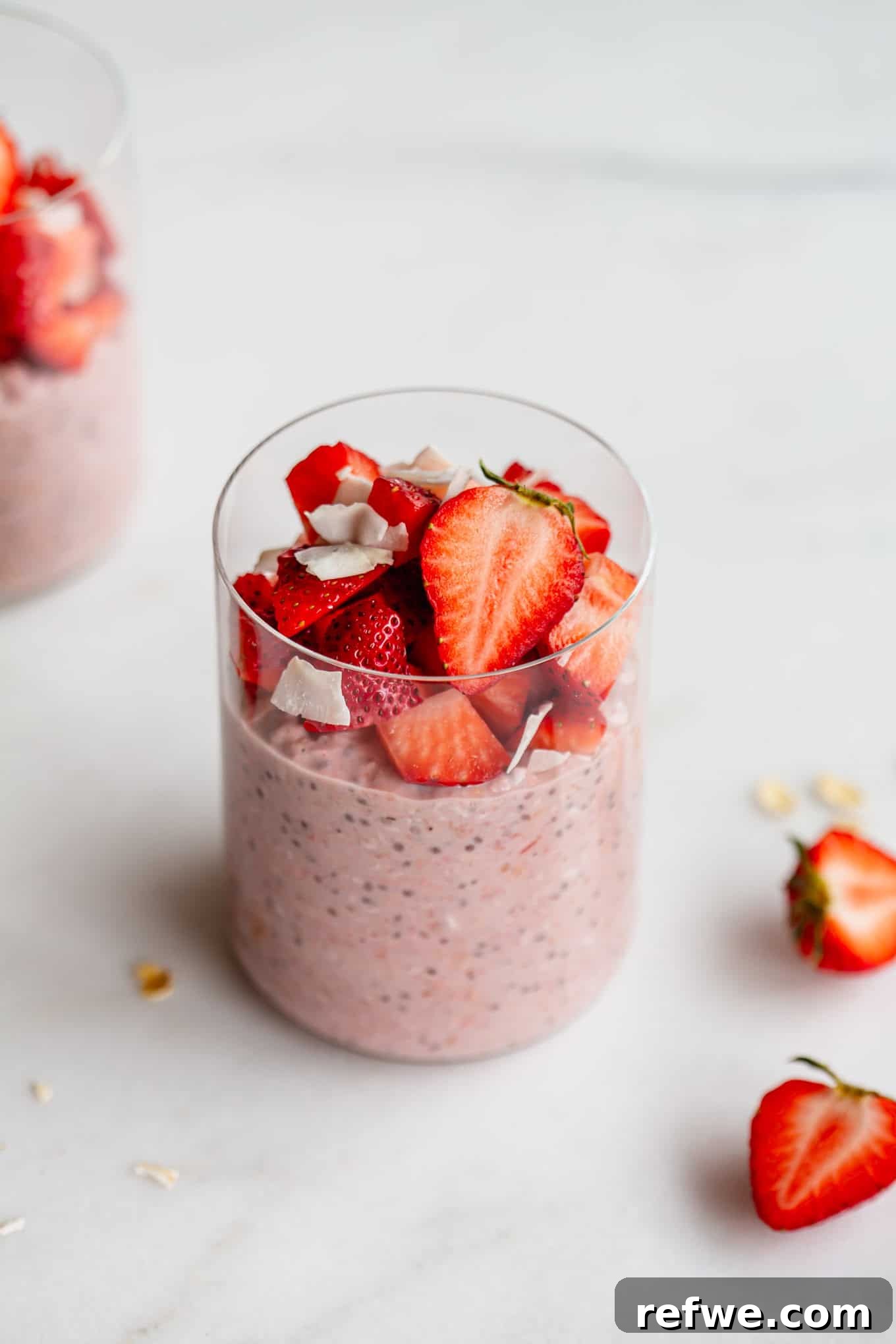 Dreamy Strawberry Overnight Oats 10 A jar of finished strawberry overnight oats, topped with fresh strawberries, sitting on a marble counter, enticingly ready for breakfast.