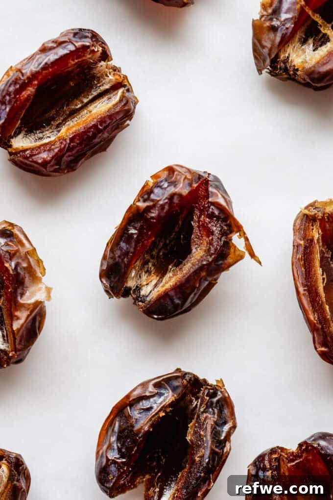 Snickers Dream Dates 4 Perfectly prepared Medjool dates with pits removed, ready for stuffing, illustrating the first crucial step in making delicious Snickers Stuffed Dates.