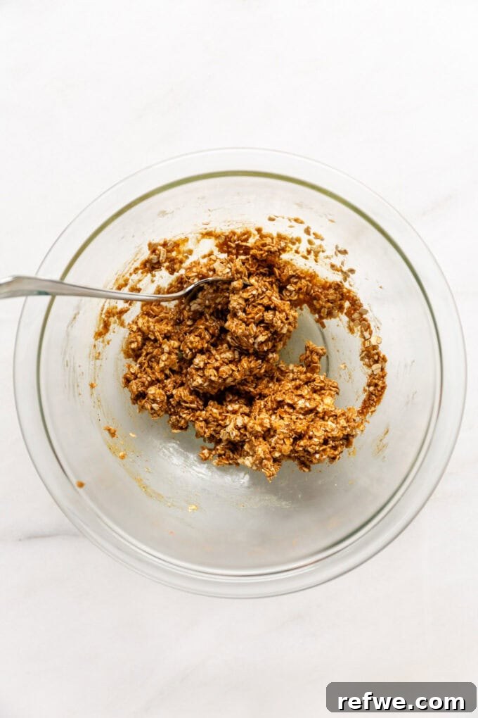 The quick granola mixture after being thoroughly combined in a mixing bowl, ready for the muffin pan.