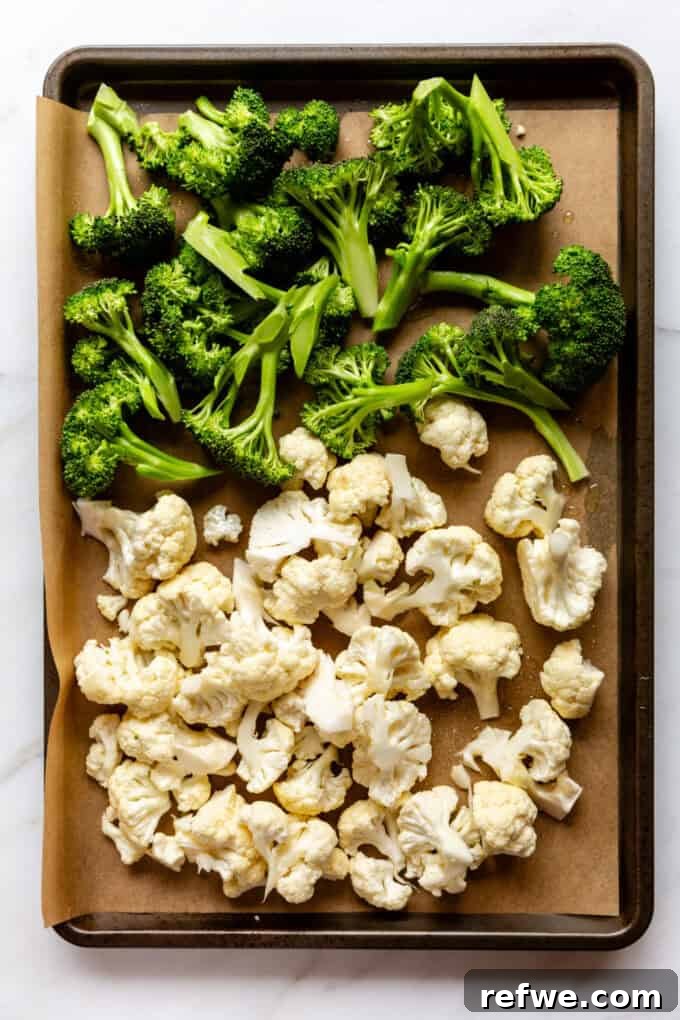 Golden Roasted Cauliflower and Broccoli Bisque 4 uncooked cut up broccoli and cauliflower on a baking sheet