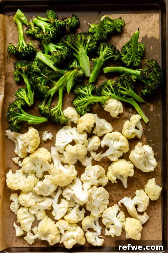 Golden Roasted Cauliflower and Broccoli Bisque 5 roasted broccoli and cauliflower on a baking sheet