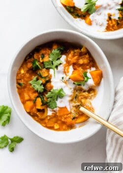 A bowl of sweet potato lentil curry topped with cilantro