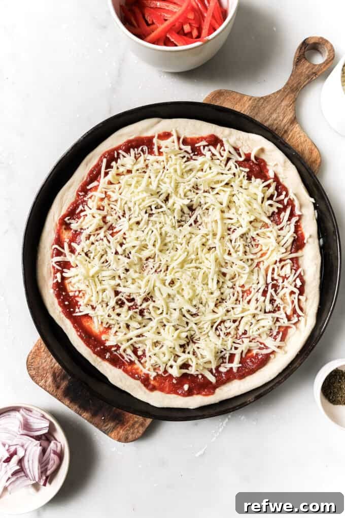 Sun-Kissed Mediterranean Pizza 6 pizza dough topped with pizza sauce and shredded cheese