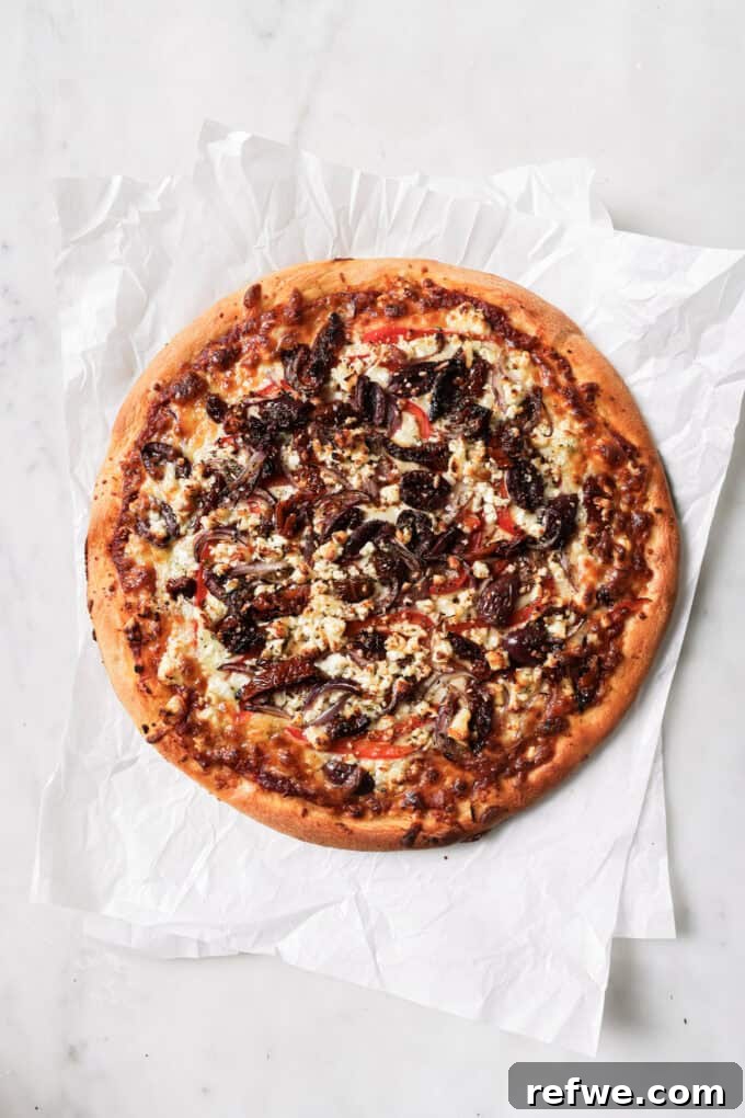 Sun-Kissed Mediterranean Pizza 8 a cooked mediterranean pizza on parchment paper