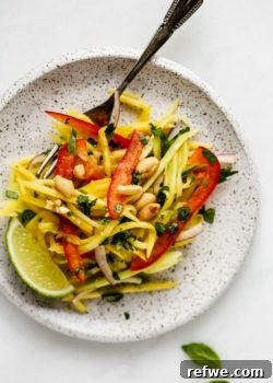 a white plat with mango salad on it