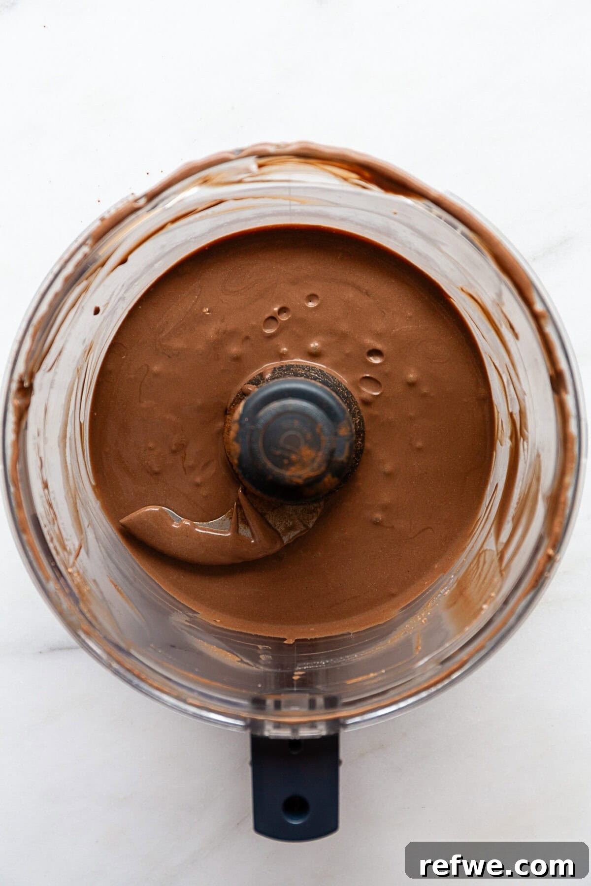 blended cottage cheese, coconut milk, cocoa, maple syrup and vanilla in a food processor.