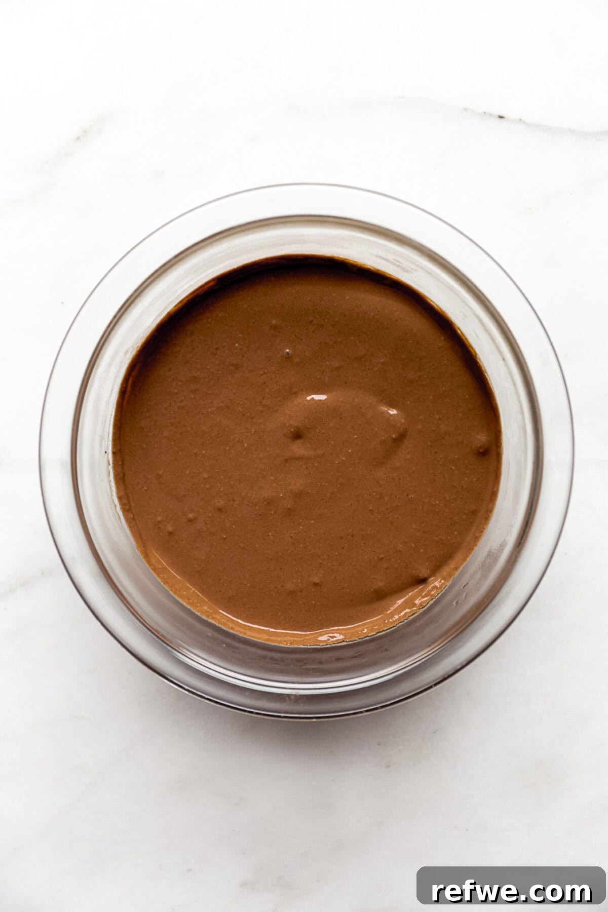 cottage cheese chocolate mousse in a clear mixing bowl.