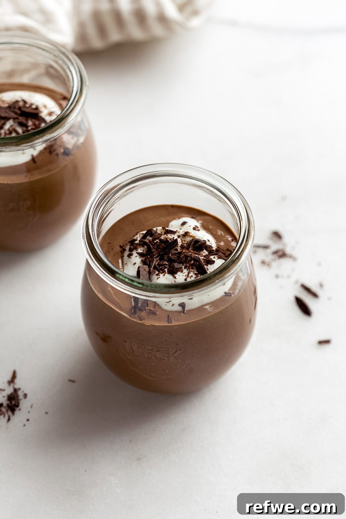 cottage cheese chocolate mousse in a small jar with yogurt and chocolate on top.