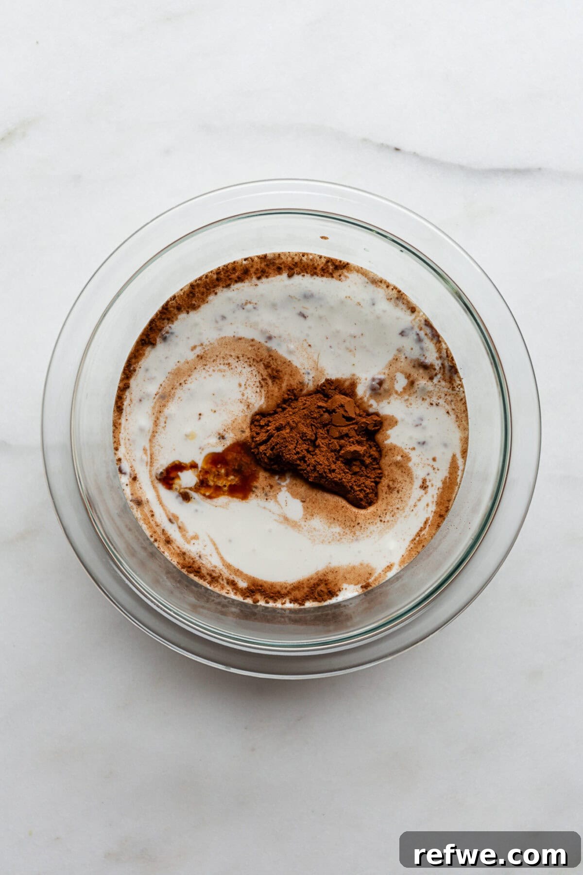 Peanut Butter Chocolate Chia Delight 4 coconut milk, cocoa powder, vanilla extract, maple syrup and chia seeds in a clear mixing bowl.