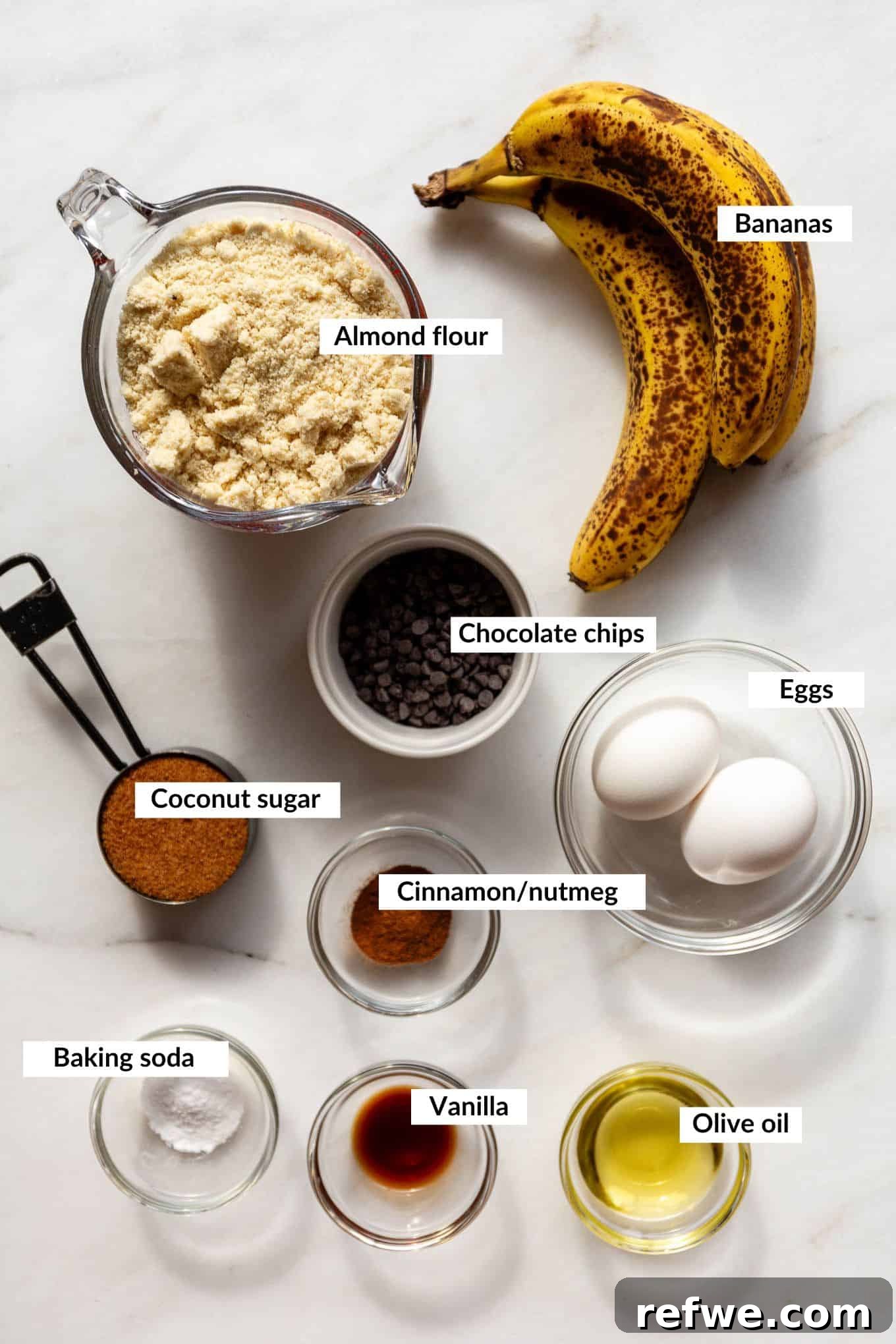 Wholesome Almond Banana Muffins 3 A selection of key ingredients laid out for making almond flour banana muffins, including bananas, eggs, flour, and spices.
