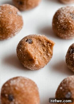 A banana protein ball with a bite taken out of it, showcasing its texture.