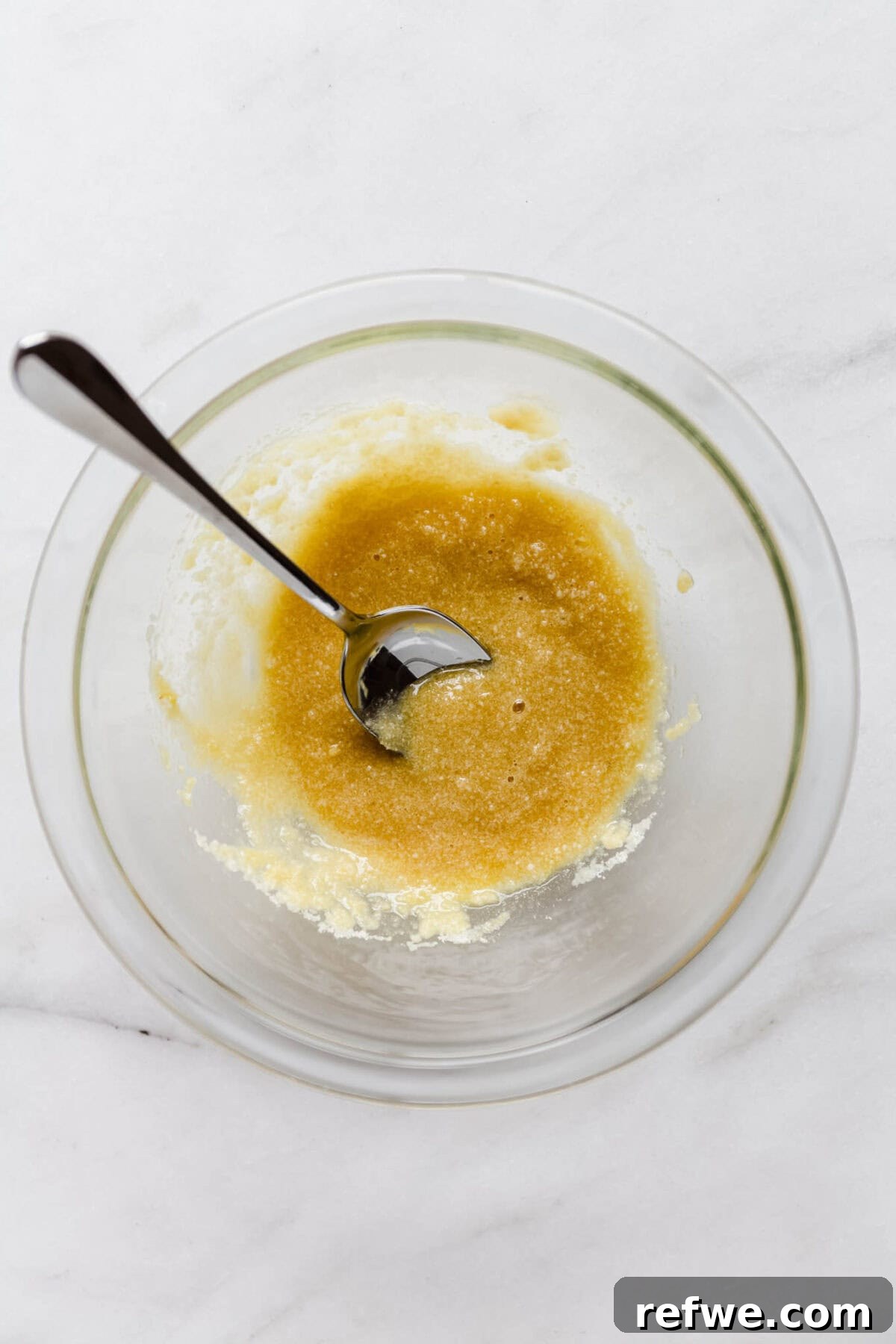 Almond paste ingredients being mixed together in a bowl.