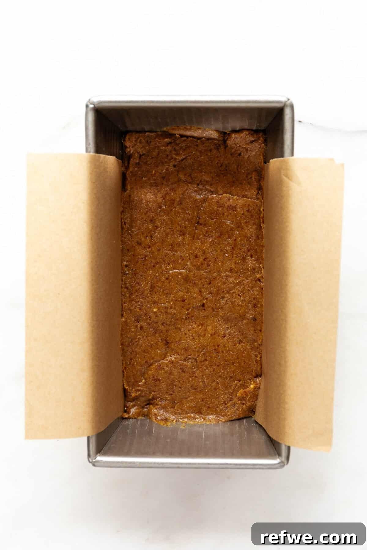 Date Caramel Chocolate Indulgence 6 Date caramel mixture pressed evenly into a loaf pan lined with parchment paper.