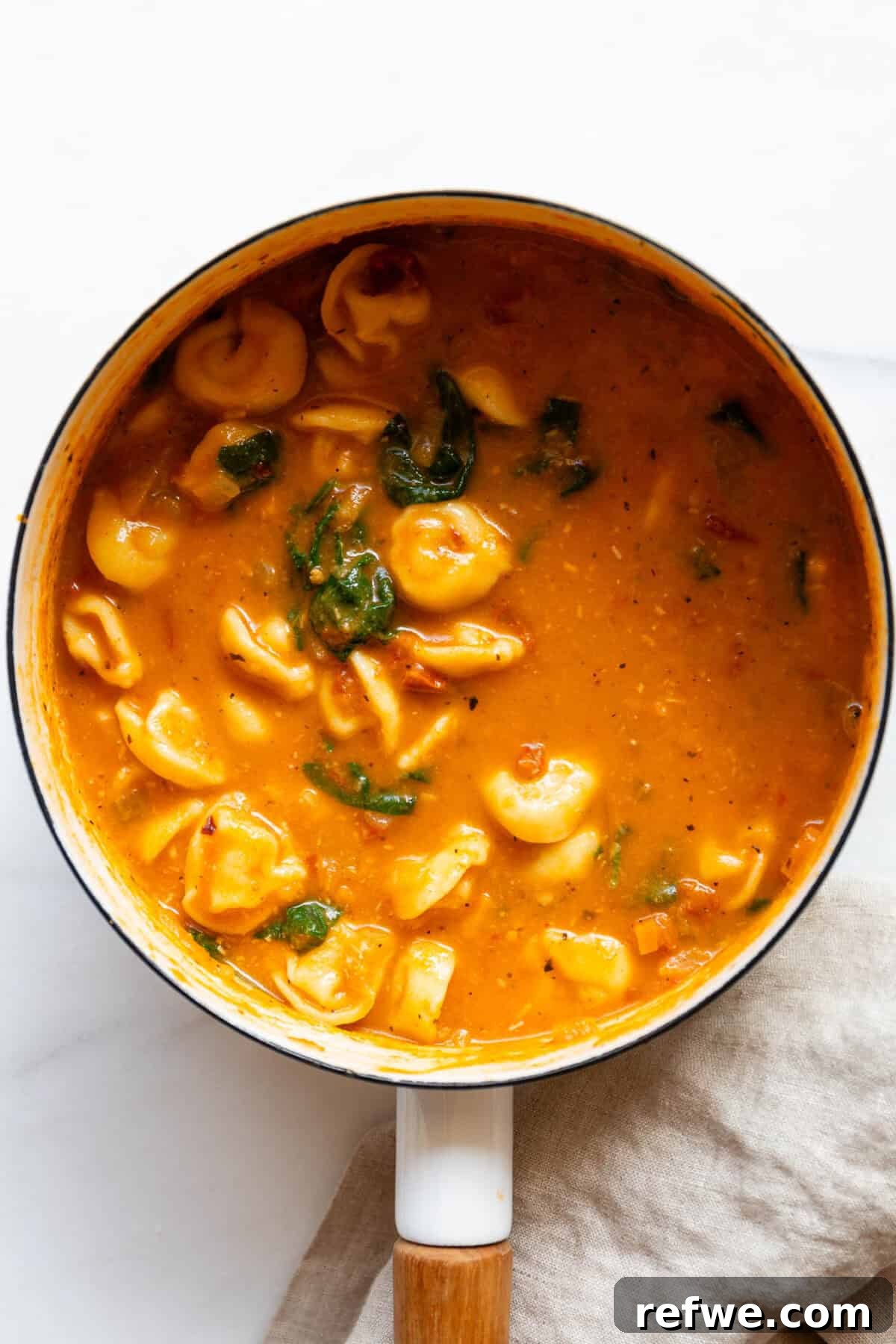 Velvety Tuscan Tortellini Soup 11 A large pot filled with the finished creamy Tuscan tortellini soup, ready to be served.