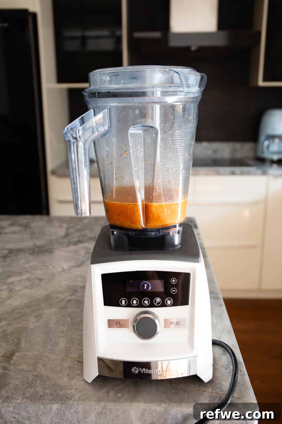 Velvety Tuscan Tortellini Soup 8 Half of the Tuscan soup broth being blended in a Vitamix blender, creating a creamy texture.