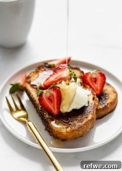 A plate of vegan French toast with maple syrup being poured on it